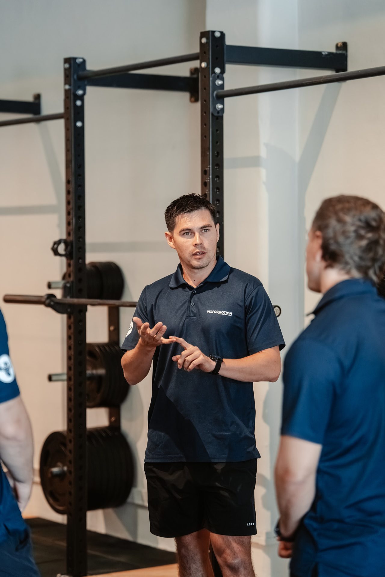 Exercise physiologist talking through a session with a client at PerforMotion
